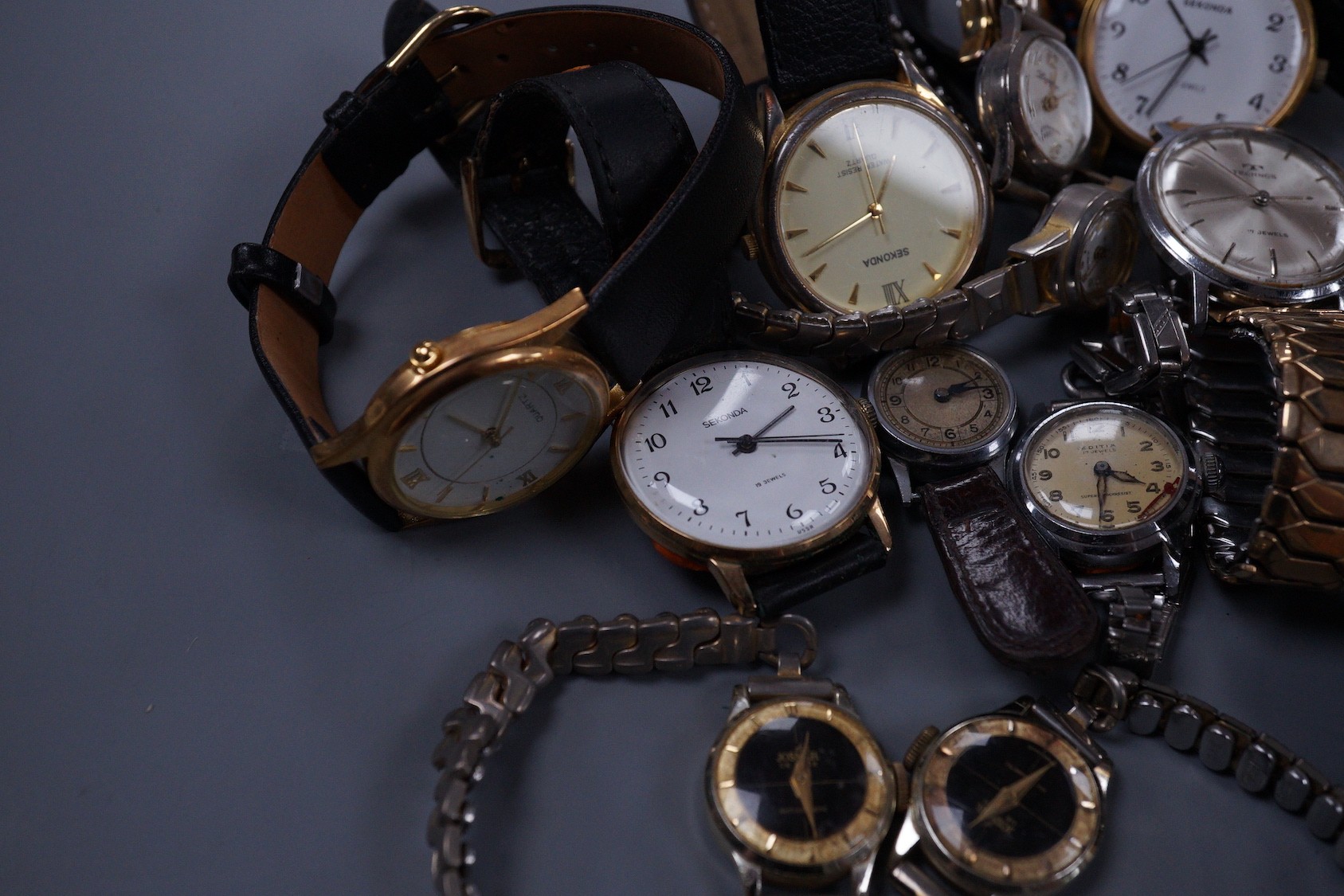 Seven assorted gentleman's wrist watches including steel Ingersoll and steel Technics, Adano and Sekonda and twelve assorted lady's wrist watches including Timex, Editia and a yellow metal Winegartens.